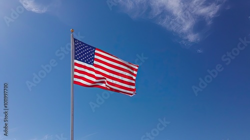 Majestic American Flag Fluttering Against a Pristine Blue Sky - Symbol of National Unity and Freedom. United States Flag Waving Proudly Against a Cloudless Sky - A Celebration of Freedom and Hope