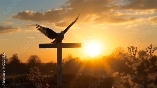 Silhouetted cross at sunset with a dove in flight, representing christ s peace on easter photo