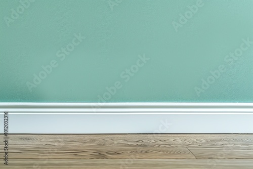 Simple minimalistic empty room with wooden floor, green painted wall and white baseboard. Suitable for various projects, concepts. Design for displaying product. Modern minimalist interior. Copy Space