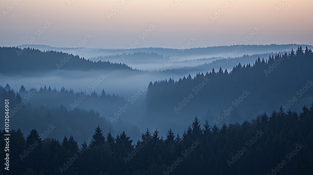 Fototapeta premium Misty mountain landscape at sunrise with a beautiful blue color palette.