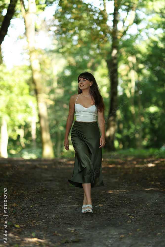 Full length portrait of beautiful woman walking in park Full length portrait of beautiful woman walking in park