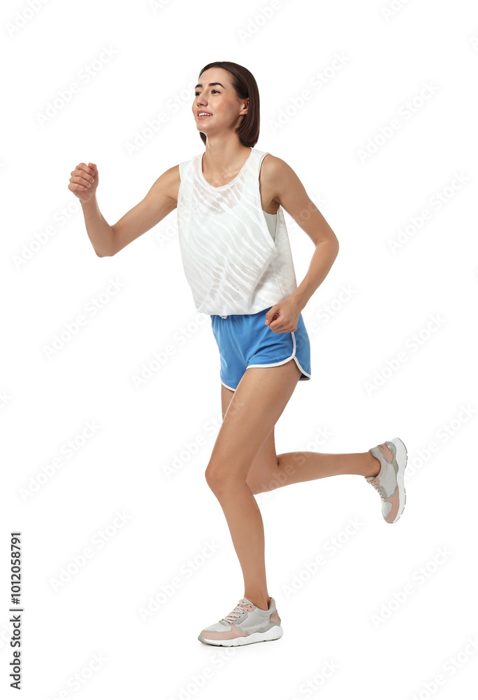 Beautiful young woman running on white background