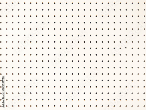 Background of white peg board with holes