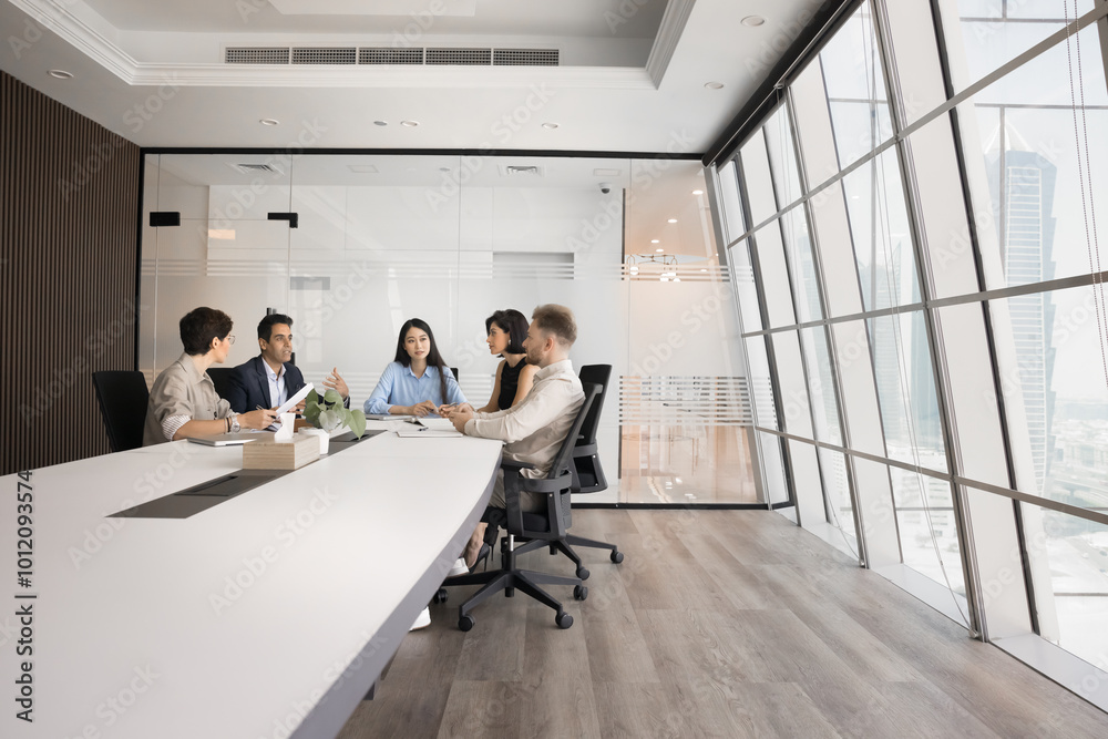 © fizkes - Diverse group of company stakeholders talking at large table in contemporary office workspace. Business colleagues discussing teamwork in stylish meeting room interior. Wide shot with copy space © fizkes - Diverse group of company stakeholders talking at large table in contemporary office workspace. Business colleagues discussing teamwork in stylish meeting room interior. Wide shot with copy space