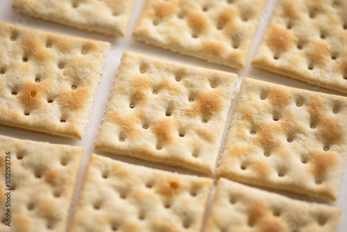 Schilderij op canvas closeup of saltine crackers on white background