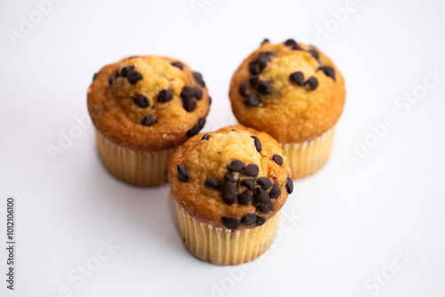 three chocolate chip mini muffins on white background