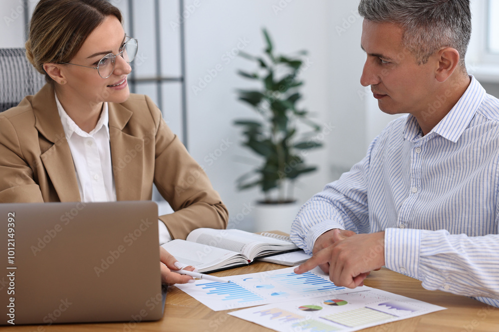 Fototapeta premium Banker working with client at wooden table in office