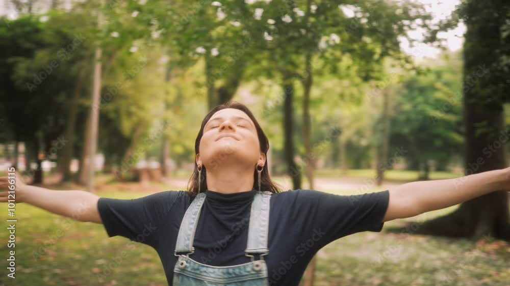 Carefree woman enjoying nature with arms wide open in a peaceful park. Happy young woman spinning with joy, embracing freedom and positive energy outdoors Carefree woman enjoying nature with arms wide open in a peaceful park. Happy young woman spinning with joy, embracing freedom and positive energy outdoors