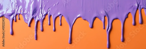 liquid purple paint dripping on orange wall photo