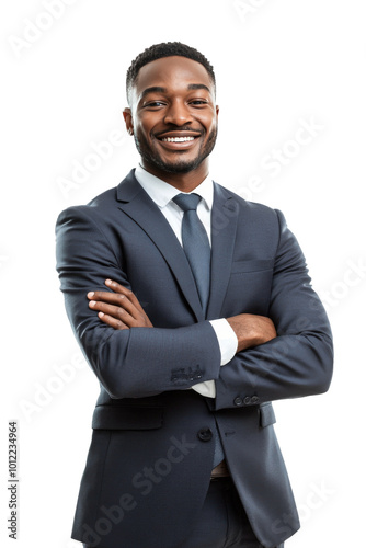 Confident businessman in a suit smiling with arms crossed against a plain bac...