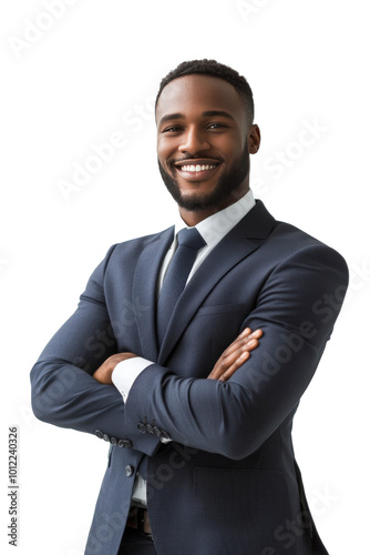 Confident businessman in a suit smiling with arms crossed against a plain bac...