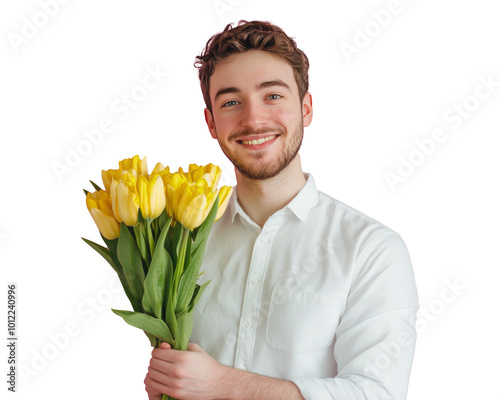 A cheerful young man holding a bouquet of yellow tulips against a pink backgr...