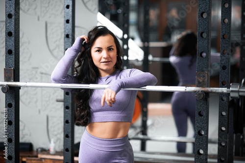 Woman Smiling While Standing by Barbell