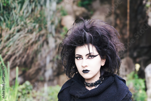 Portrait of Dark gothic fashion youg woman with black makeup, black lipstick and nose piercing.Italian beautiful brunette girl. Dark lady. Dark girl. Trad goth girl.  Close-up photo