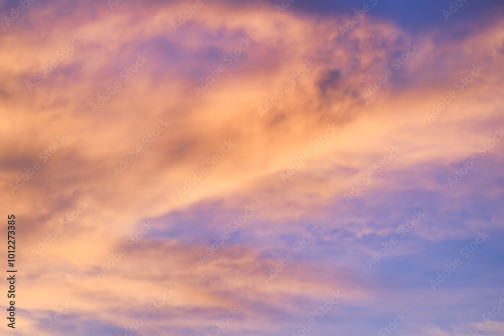 A beautiful sky tinted by the sun leaving vibrant shades of gold, pink, blue and multicolored. Clouds in the twilight evening and morning sky. Cloudy sky background in the evening, and during the day. A beautiful sky tinted by the sun leaving vibrant shades of gold, pink, blue and multicolored. Clouds in the twilight evening and morning sky. Cloudy sky background in the evening, and during the day.