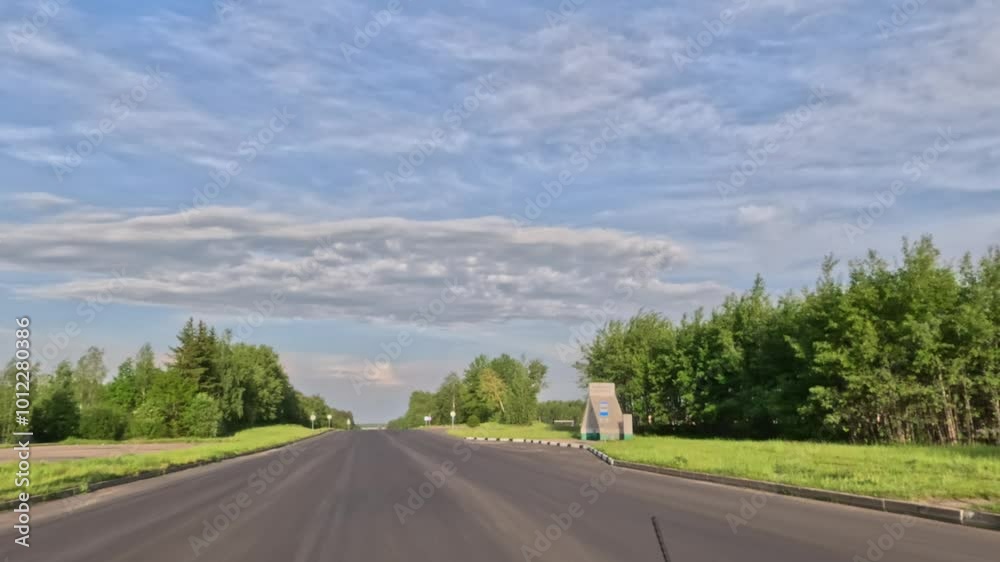 Road view on a summer day. Highways, roadside and white road line markings. Road view on a summer day. Highways, roadside and white road line markings.