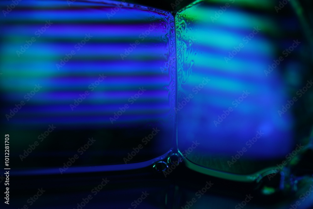 Blue and green flat liquid panels, fluid surface, fluid movement, fantastic shapes on the dark background Blue and green flat liquid panels, fluid surface, fluid movement, fantastic shapes on the dark background