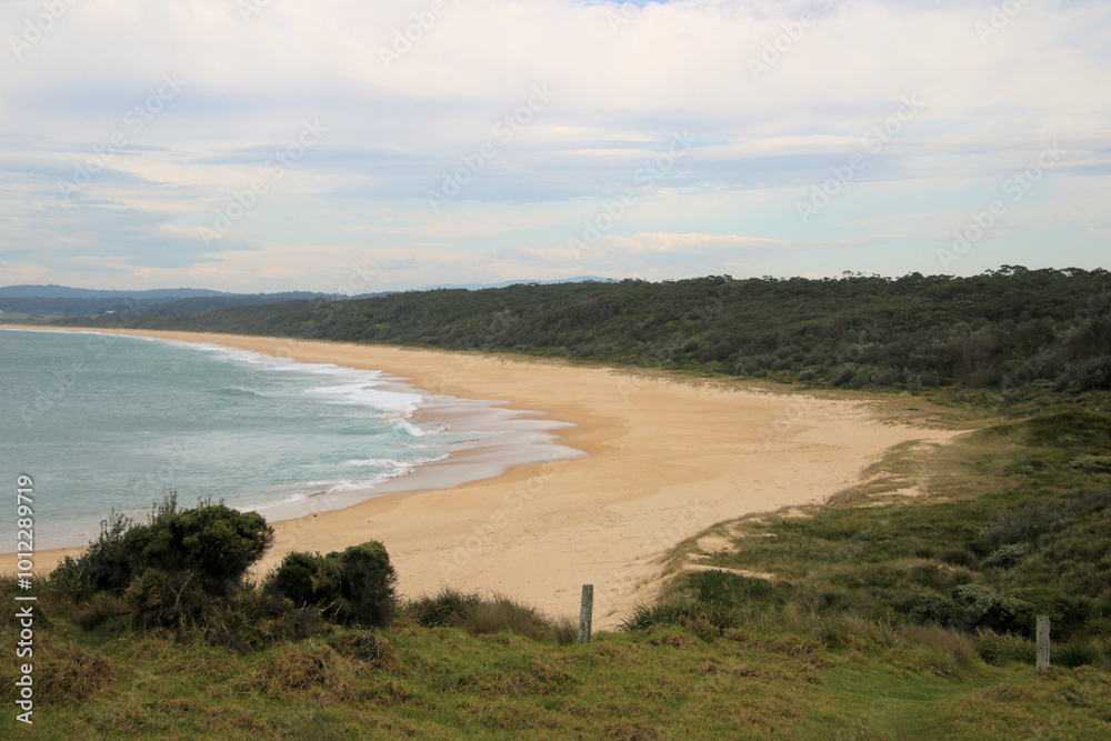 Haywards Beach at Wallaga Lake on the south coast of New South Wales, Australia. A beautiful sandy beach with surf waves. Haywards Beach at Wallaga Lake on the south coast of New South Wales, Australia. A beautiful sandy beach with surf waves.