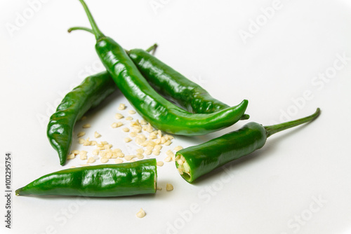 Fresh serrano pepper (Capsicum annuum 'Serrano') on isolated white background with pepper seeds itself (Cabai Serrano di latar belakang warna putih beserta bijinya) photo