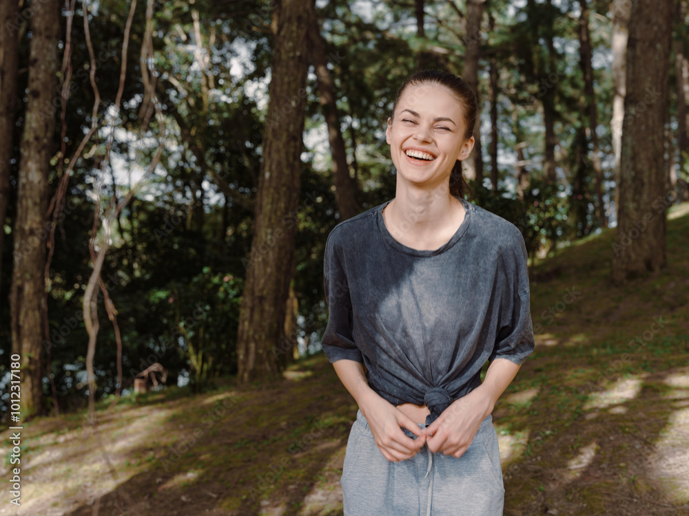 Joyful young woman smiling outdoors in a forest, wearing a casual outfit, enjoying nature and the sunshine Happiness and connection with nature theme Joyful young woman smiling outdoors in a forest, wearing a casual outfit, enjoying nature and the sunshine Happiness and connection with nature theme