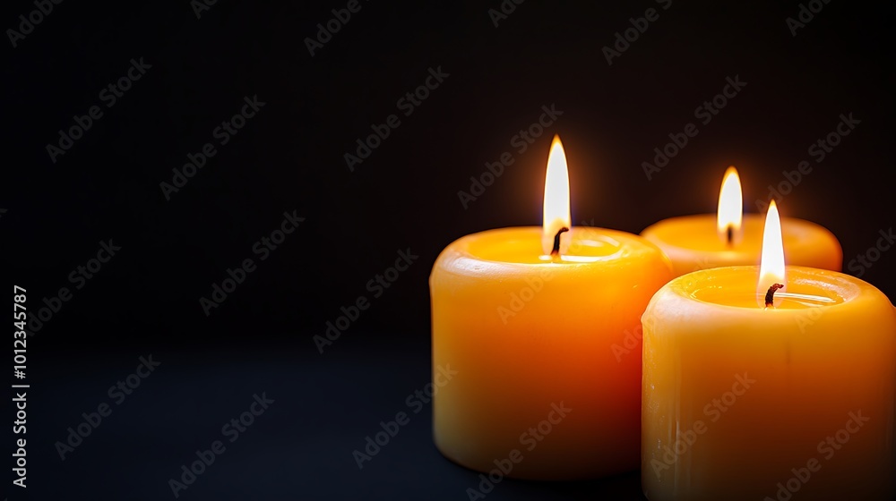 A soft, glowing candles in the dark background with a clear, open space for text A soft, glowing candles in the dark background with a clear, open space for text