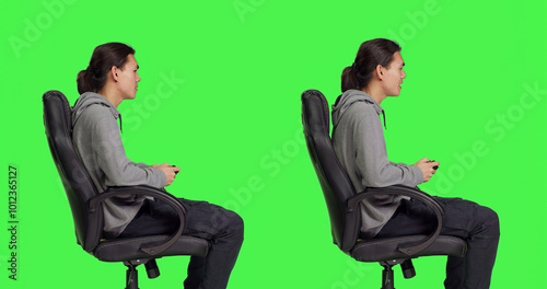 Фотография Player having fun with rpg competition over greenscreen in studio, playing videogames online with friends