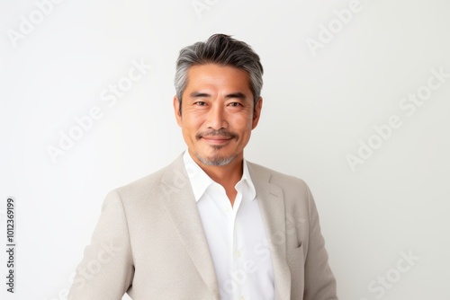 Portrait of mature asian man in business suit on white background