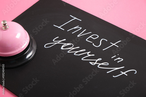 white chalk marker writing on black board, invest in yourself, top view copy space, reception call, self care time, self love,