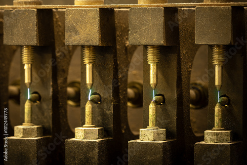 Sparks fly from the points of a magneto testing machine.  Designed to troubleshoot and inspect the function of the charge generating component, electricity jumps the gap for each section photo