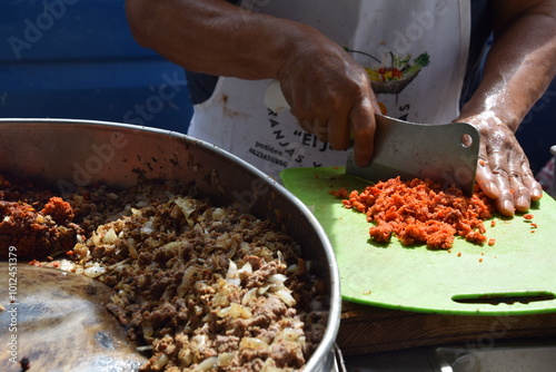 man chopping chorizo in mexico up close