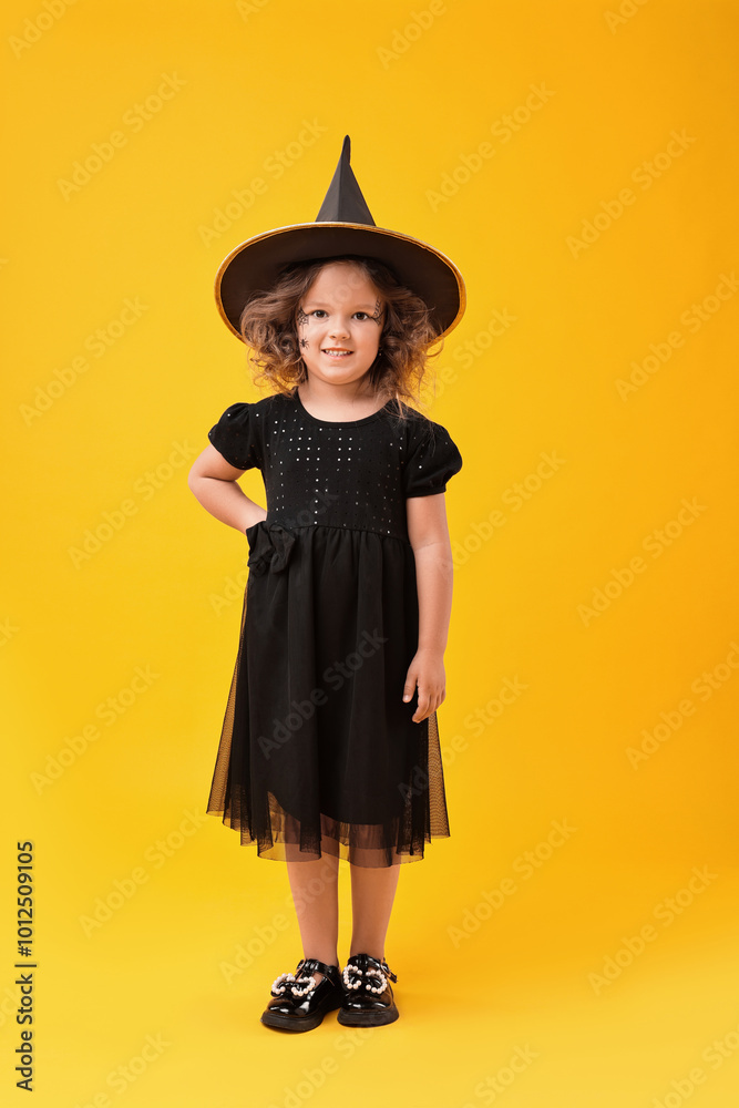 Cute girl dressed like witch on yellow background. Halloween costume Cute girl dressed like witch on yellow background. Halloween costume