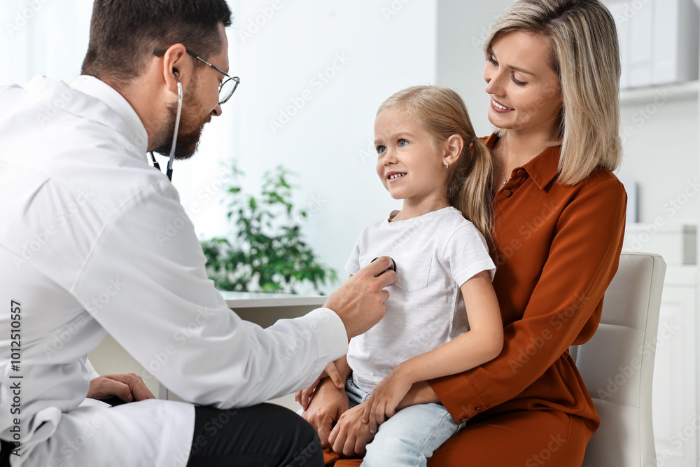 Doctor examining little girl with stethoscope and her mother in hospital Doctor examining little girl with stethoscope and her mother in hospital
