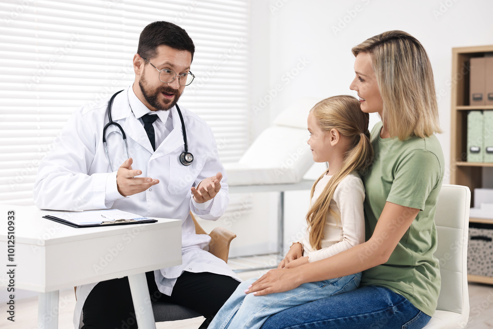 Doctor consulting little girl and her mother in hospital Doctor consulting little girl and her mother in hospital