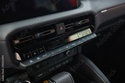 Closeup of car dashboard air vents near gear shift