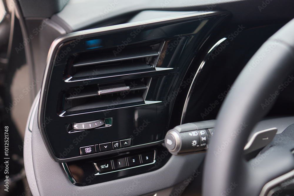 Closeup of car dashboard air vents near gear shift