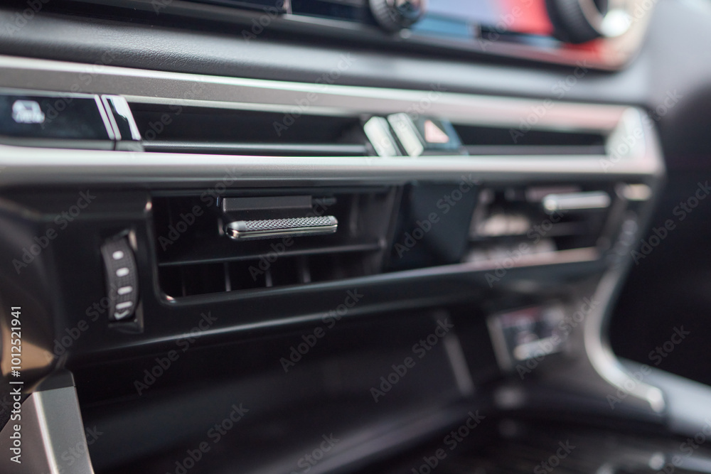 Closeup of car dashboard air vents near gear shift Closeup of car dashboard air vents near gear shift