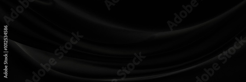 Black gray satin dark fabric texture luxurious shiny that is abstract silk cloth panorama background with patterns soft waves blur beautiful.