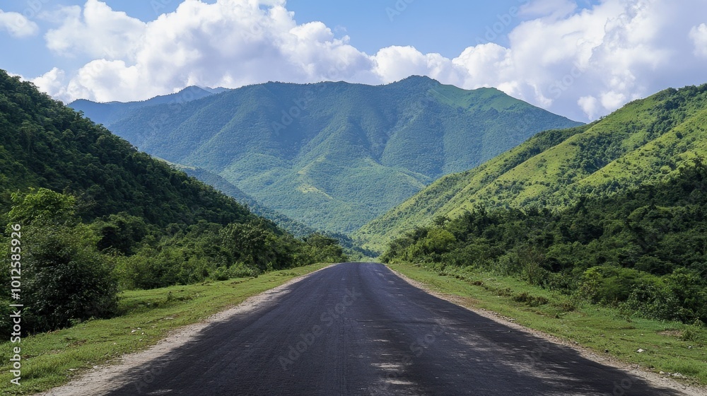 A serene asphalt road surrounded by lush green mountains, under a clear sky with soft, white clouds on a sunny day. A serene asphalt road surrounded by lush green mountains, under a clear sky with soft, white clouds on a sunny day.