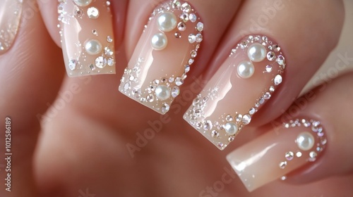 A set of nails adorned with tiny pearls and rhinestones, creating a luxurious and glamorous look for special occasions.