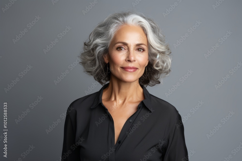 Portrait of beautiful mature businesswoman with grey hair, isolated on grey background Portrait of beautiful mature businesswoman with grey hair, isolated on grey background