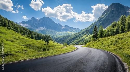 An asphalt road weaving through green mountain scenery, with a sunny sky and fluffy white clouds on a clear day.