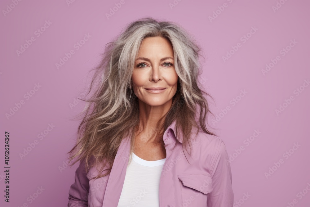 Portrait of a beautiful mature woman with long blond hair looking at camera. Portrait of a beautiful mature woman with long blond hair looking at camera.
