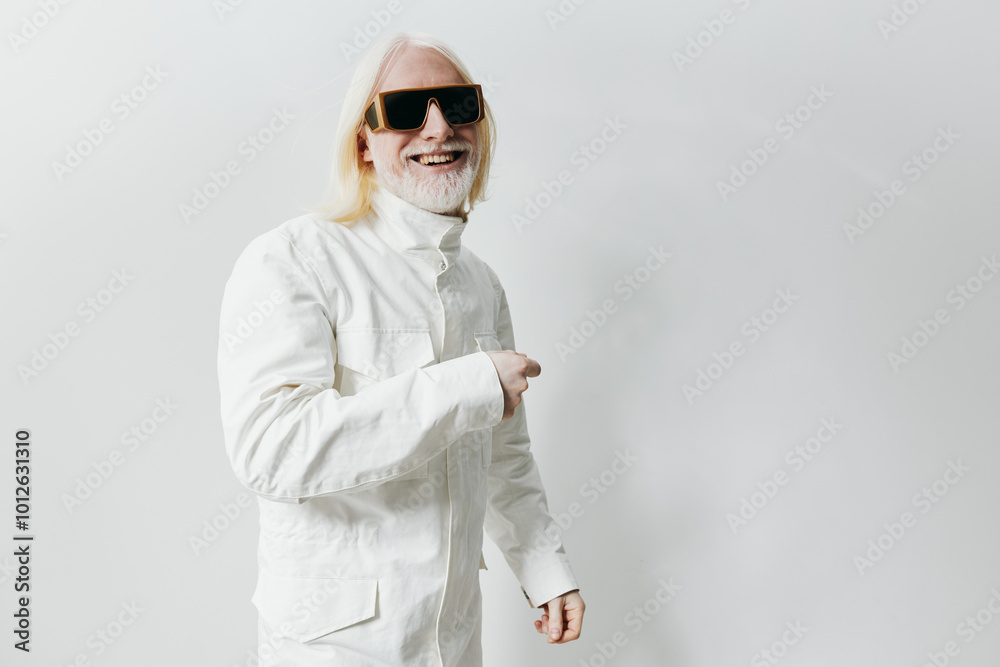Stylish man in sunglasses with long white hair, dressed in a white jacket, smiling and pointing against a clean white background, embodying modern fashion and confidence Stylish man in sunglasses with long white hair, dressed in a white jacket, smiling and pointing against a clean white background, embodying modern fashion and confidence