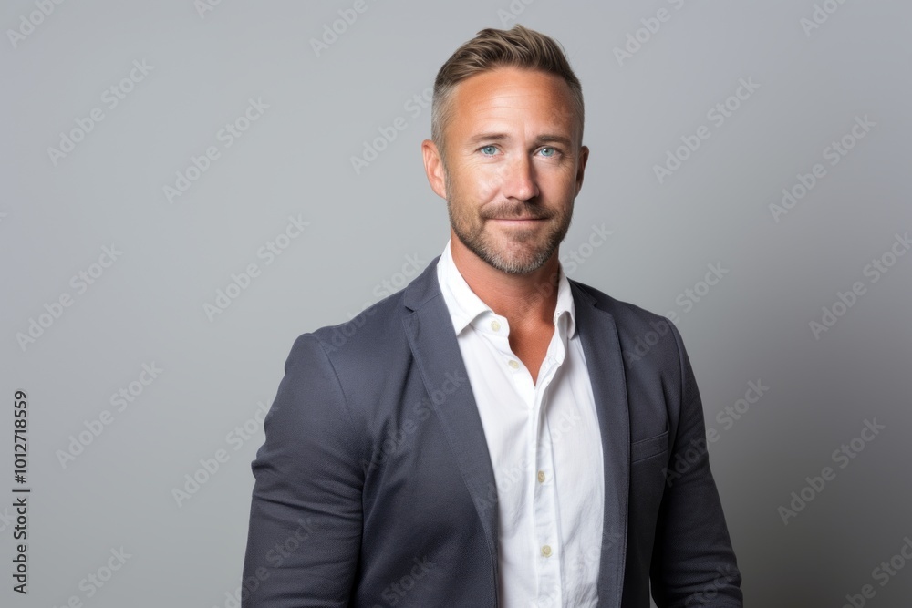 Handsome man in a suit on a gray background. Men's beauty, fashion. Handsome man in a suit on a gray background. Men's beauty, fashion.