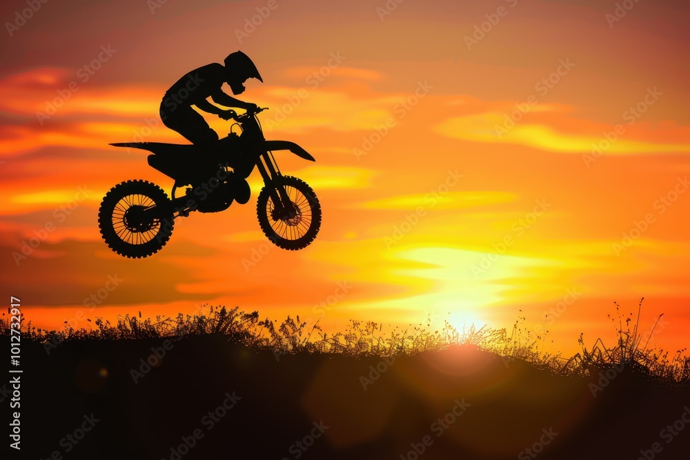 Motocross silhouette jumping over sunset light Motocross silhouette jumping over sunset light