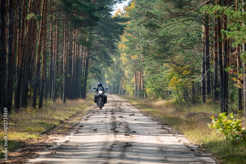 Motorbiker enjoying a forest road journey on a motorcycle fun on empty road with space for text