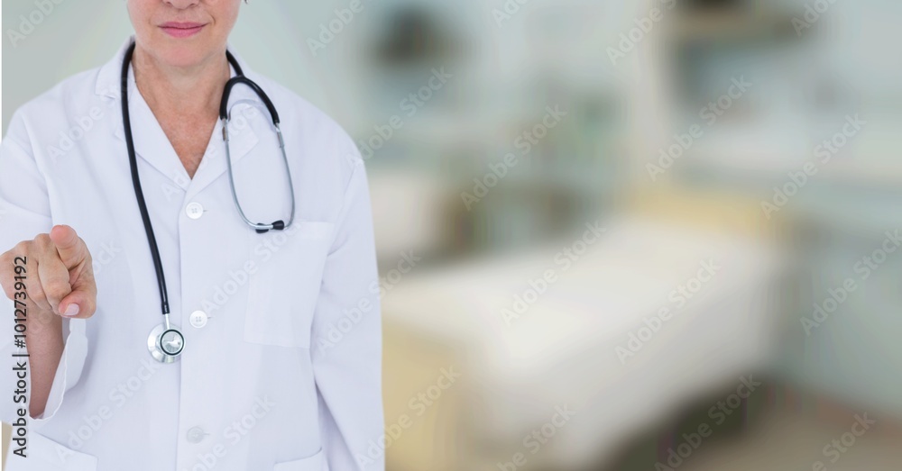 Caucasian female doctor touching an invisible screen against blur background with copy space Caucasian female doctor touching an invisible screen against blur background with copy space