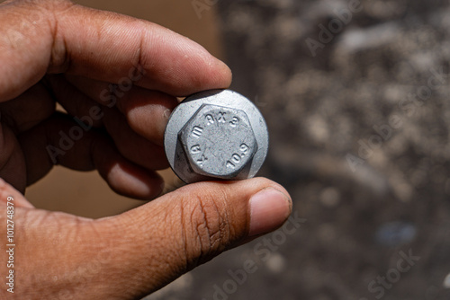 hand holding a screw