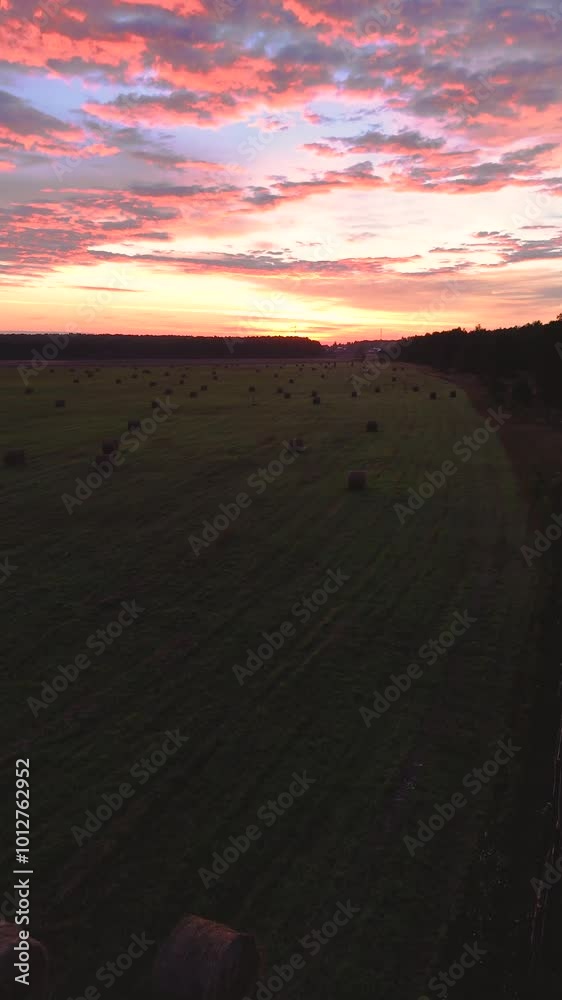 Colorful dawn in a field with hay rolls Colorful dawn in a field with hay rolls