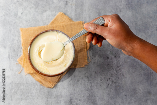 Misti doi is a traditional Bengali sweet yogurt made by caramelizing milk and sugar, known for its creamy, rich flavor. Selective focus. photo